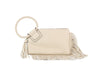 The Fringe Accented Wristlet Clutch Bag is a cream faux leather clutch with a braided circular handle, gold-tone hardware, decorative tassel, zip closure, and fringe accents along the bottom and side.