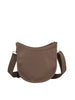 The Saddle Bag Inspired Curved Crossbody is a brown, crescent-shaped faux leather bag featuring a wide adjustable strap and top zip closure, displayed against a plain white background.