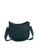 The Saddle Bag Inspired Curved Crossbody is a small, dark teal faux leather bag with a curved top, adjustable strap, minimalist style, smooth texture, and practical top zip closure.
