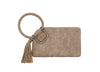 The Braided Handle Wristlet Clutch features beige suede, a large braided wrist strap, decorative tassel detail, and an interior zip pocket for essentials, displayed on a white background.