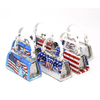 The American Flag Lipstick Case Assorted Set includes four small faux leather rectangular cases with white handles, featuring American flag patterns, stars, and the Statue of Liberty—all arranged on a white background.