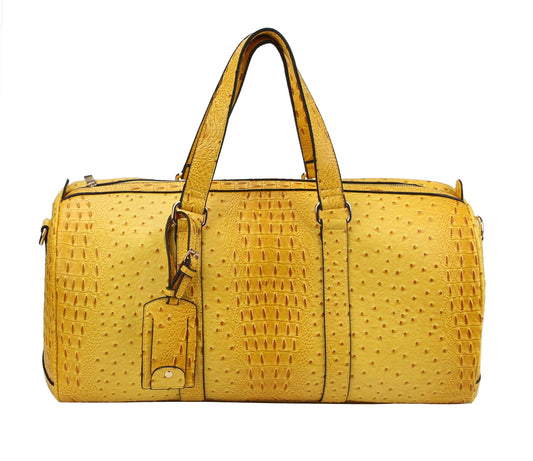 The Large Alligator Embossed Duffle Set is a yellow faux leather travel bag with an alligator-patterned surface, two top handles, a luggage tag, and a zipper closure.