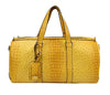 The Large Alligator Embossed Duffle Set is a yellow faux leather travel bag with an alligator-patterned surface, two top handles, a luggage tag, and a zipper closure.