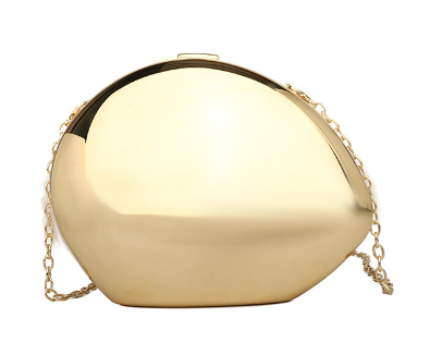 The Modern Patent Shoulder Bag features a shiny gold metallic finish, smooth rounded shape, and a delicate gold chain strap, radiating elegance against a white background.