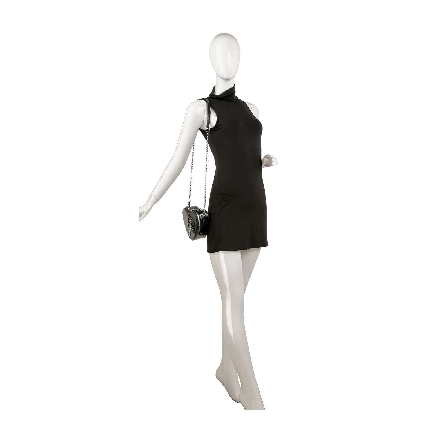 A white mannequin in a sleeveless black mini dress holds the Modern Heart Petite Shoulder Bag by its chain strap, posed with one arm outstretched.