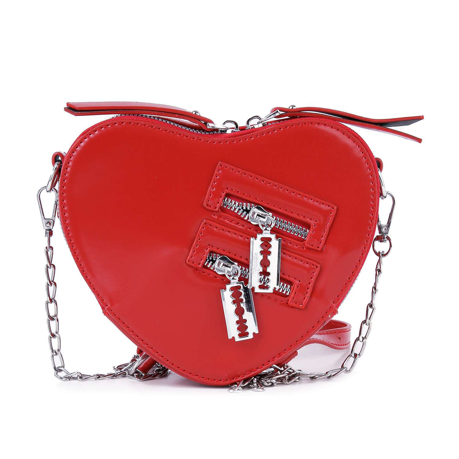 The Modern Heart Petite Shoulder Bag is a red, heart-shaped faux leather purse with a silver chain strap, two diagonal zip pockets with razor blade-shaped pulls, and a glossy finish—making it a bold standout accessory.