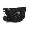 The Sparkling Rhinestone Crossbody Sling is a black faux leather bag with small black studs, a silver zipper, a triangular silver logo plate, and an adjustable strap with a silver clasp.
