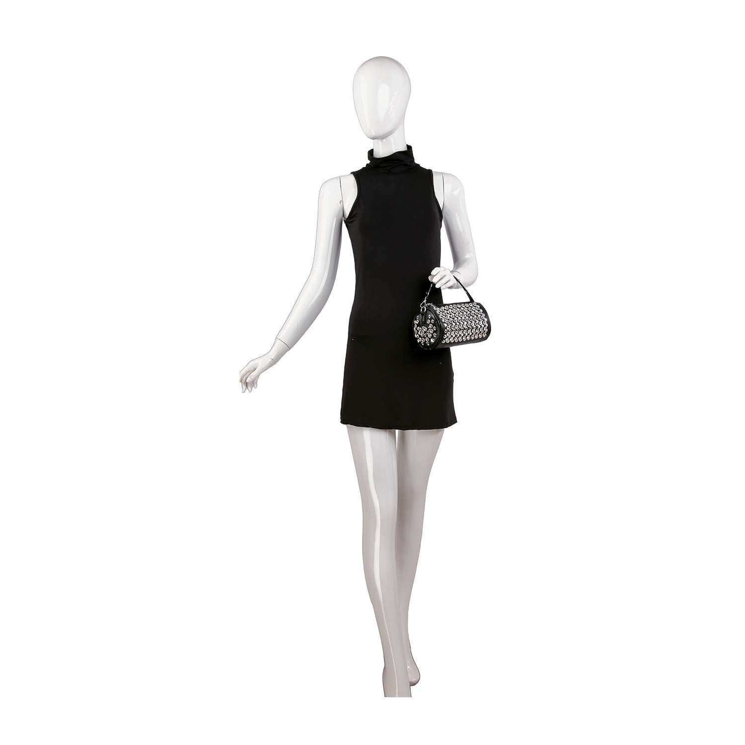 A white mannequin wears a sleeveless, high-neck black mini dress and carries the Studded Rhinestone Barrel Bag on its right arm, posed against a plain white background.