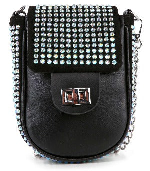 The Decorative Top Flap Cell Phone Crossbody is a small black purse with a silver chain strap, silver-toned hardware, and a flap adorned with rows of shiny rhinestones. It features a lined interior and front turn-lock clasp for function and style.