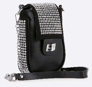 The Decorative Top Flap Cell Phone Crossbody is a small black bag with a silver-studded flap, silver clasp, and hardware. It has a detachable chain strap and lined interior for stylish practicality.