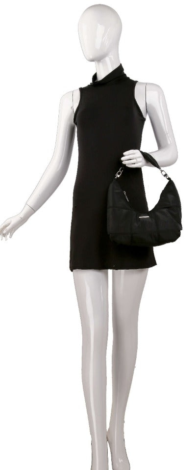 A mannequin wearing a sleeveless, short black dress and holding the Stylish Quilted Nylon Hobo Handbag.