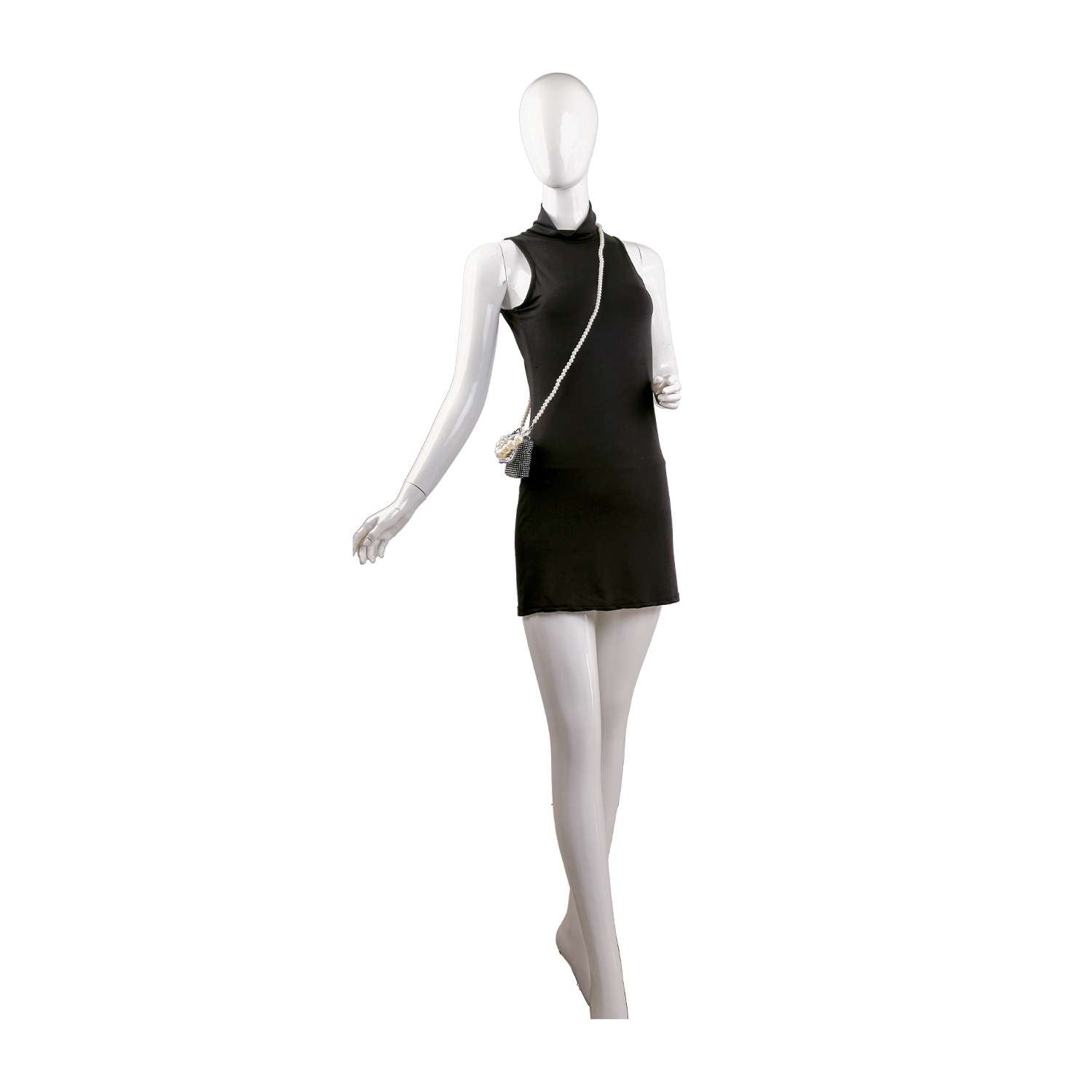 A white mannequin wears a sleeveless, high-neck black mini dress paired with the Pearl And Rhinestone Accented Ultra Petite Evening Bag. One arm is bent, and the other extended, highlighting this chic ensemble.