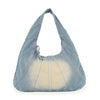 The Distressed Denim Hobo Handbag is a light blue, wide crescent-shaped shoulder bag with prominent stitched panels, a faded center, tablet-friendly design, decorative handle bow, and practical everyday style.
