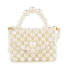 The Ultra Petite Pearl Evening Bag is a small, rectangular handbag made of shiny white imitation pearls with a pearl handle and elegant gold accents on the sides.