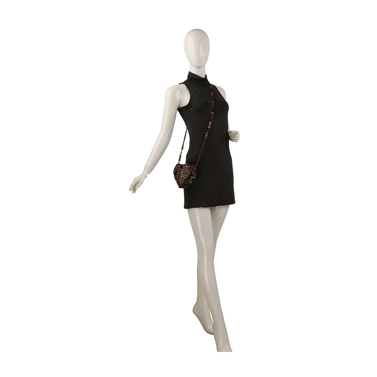A mannequin wears a sleeveless black mini dress and carries the Heart Design Decorative Evening Bag, posed as if walking with one arm slightly extended.