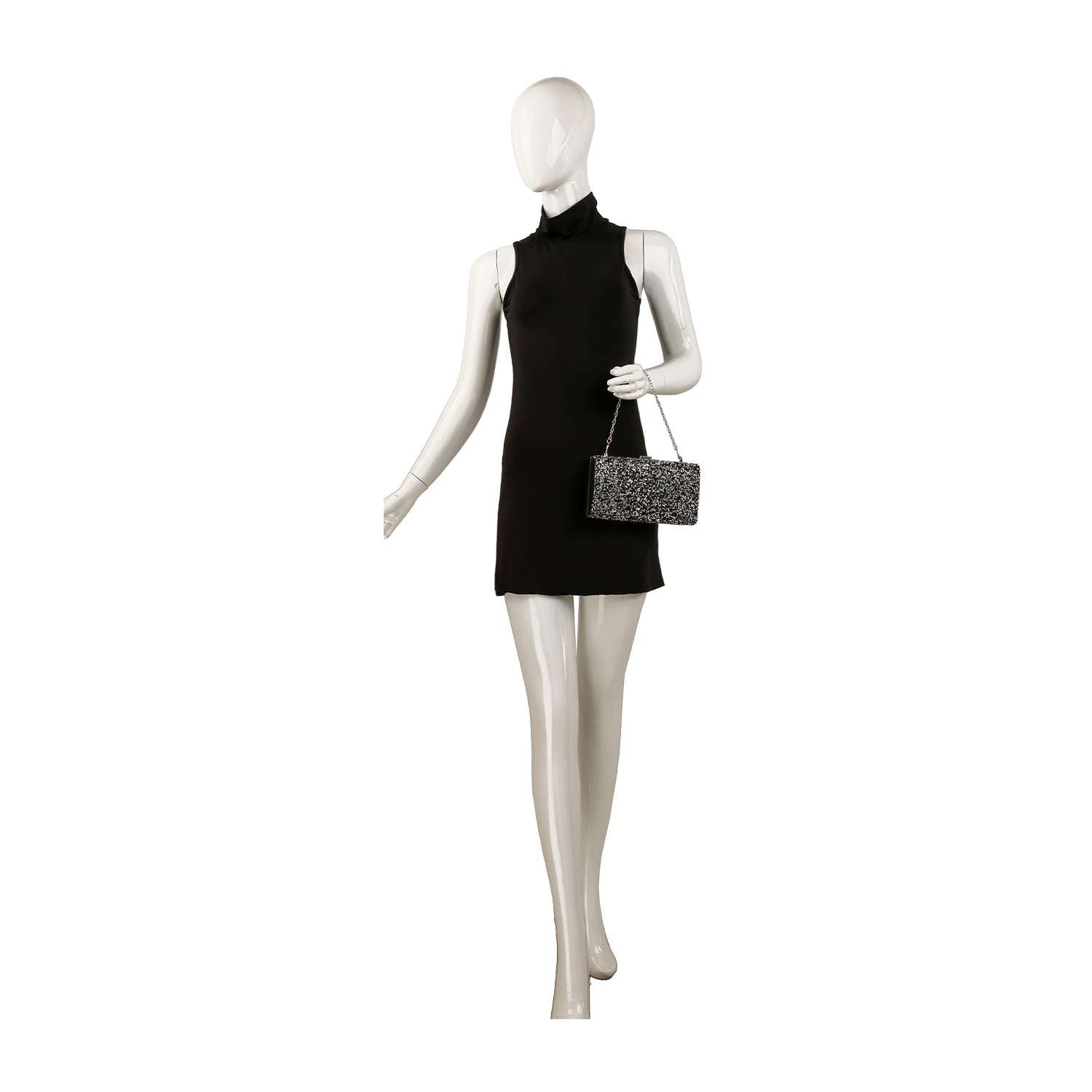 A mannequin in a sleeveless, high-neck black mini dress holds the Dazzling Cluster Stone Accented Evening Bag—a small, rectangular clutch with a detachable strap—while standing on a white background.