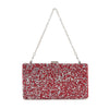 The Dazzling Cluster Stone Accented Evening Bag is a rectangular clutch with red and silver glitter, a silver chain strap, and a metallic clasp. Made from faux leather for durability and style.