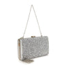 The Dazzling Cluster Stone Accented Evening Bag is a rectangular silver clutch purse with glitter, a silver chain, and clasp closure, shown upright on a white background.