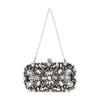 The Highly Decorative Retro Evening Bag is a small black evening bag with intricate silver and clear gemstone floral embellishments, a jeweled clasp, and a chain handle.