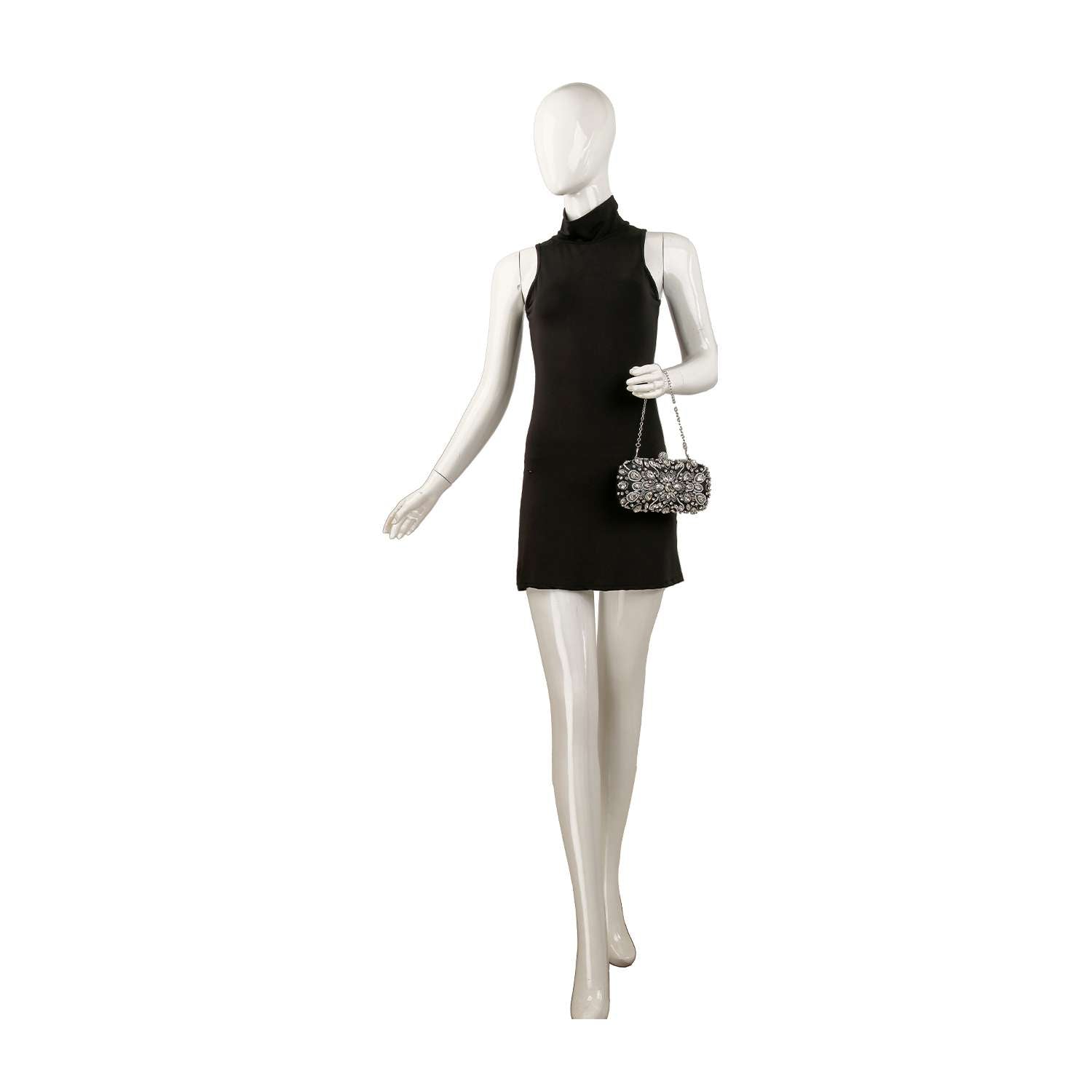 A mannequin in a sleeveless black mini dress holds the Highly Decorative Retro Evening Bag, a sparkly silver accessory with a chain handle, standing against a white background.