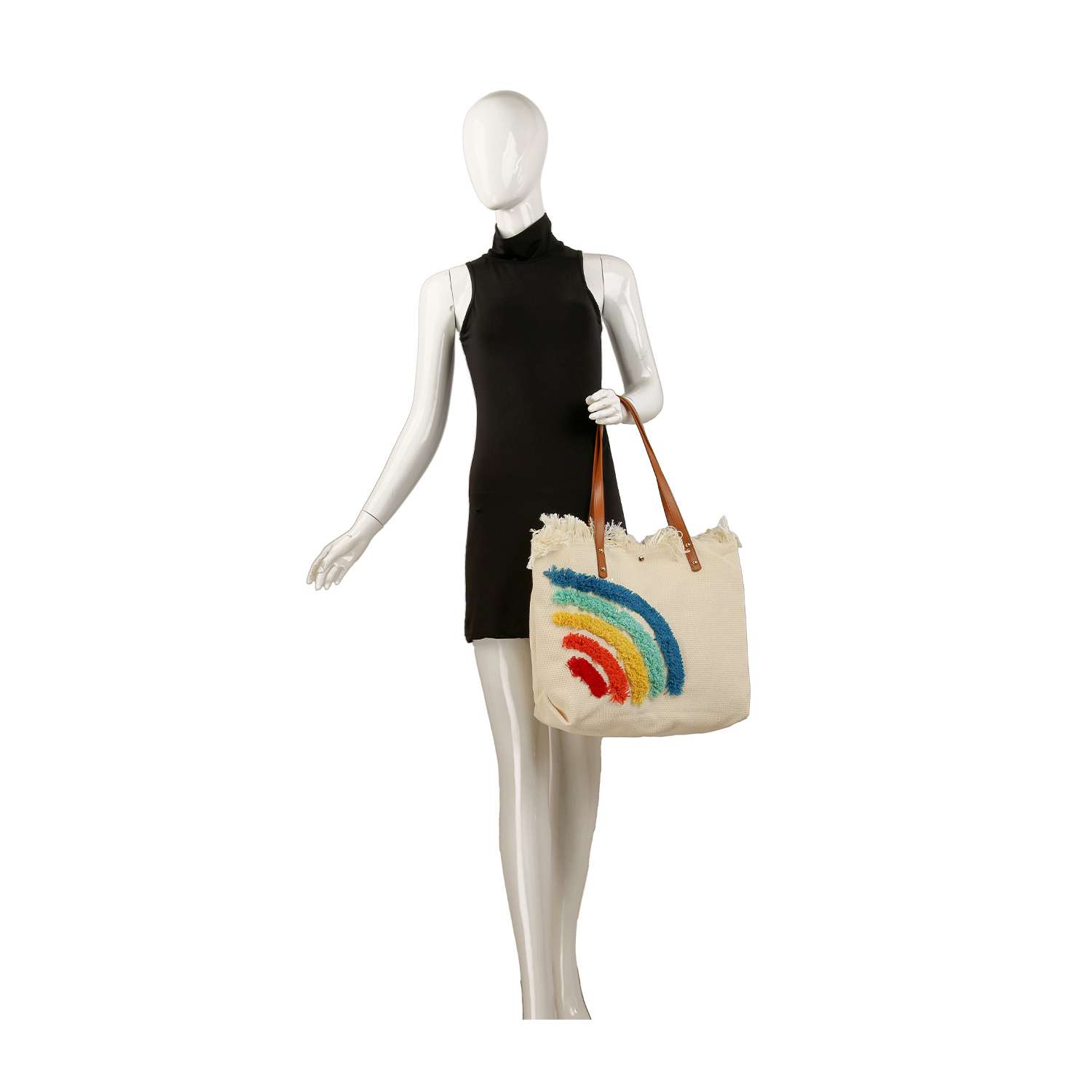 A mannequin in a sleeveless black dress holds the Canvas Rainbow Design Tote, a beige bag with brown straps and a vibrant rainbow print, perfect for carrying a tablet.