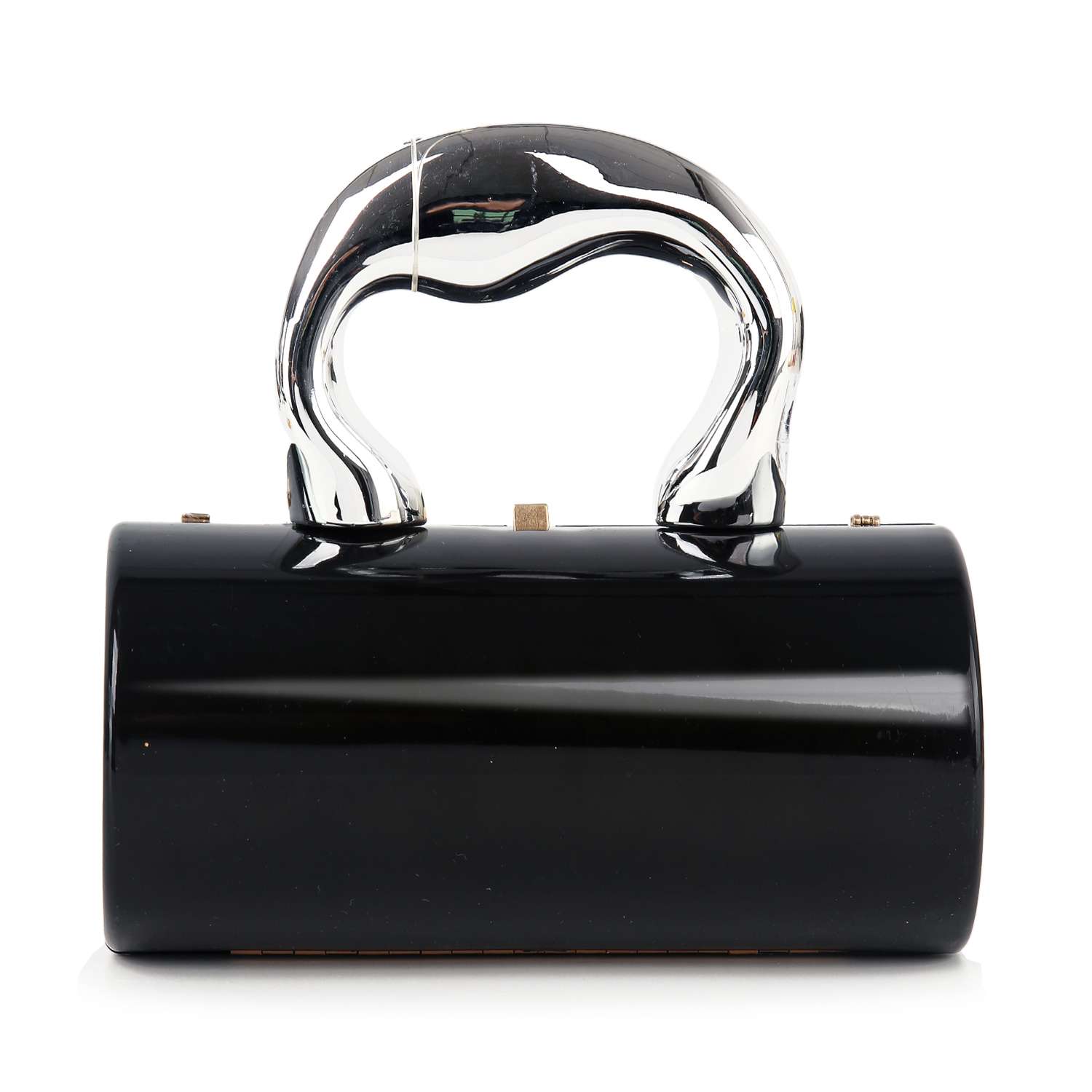 The Patent Petite Evening Bag is a black cylindrical evening bag made of faux leather, featuring a shiny silver sculptural Art Deco handle, shown against a white background.