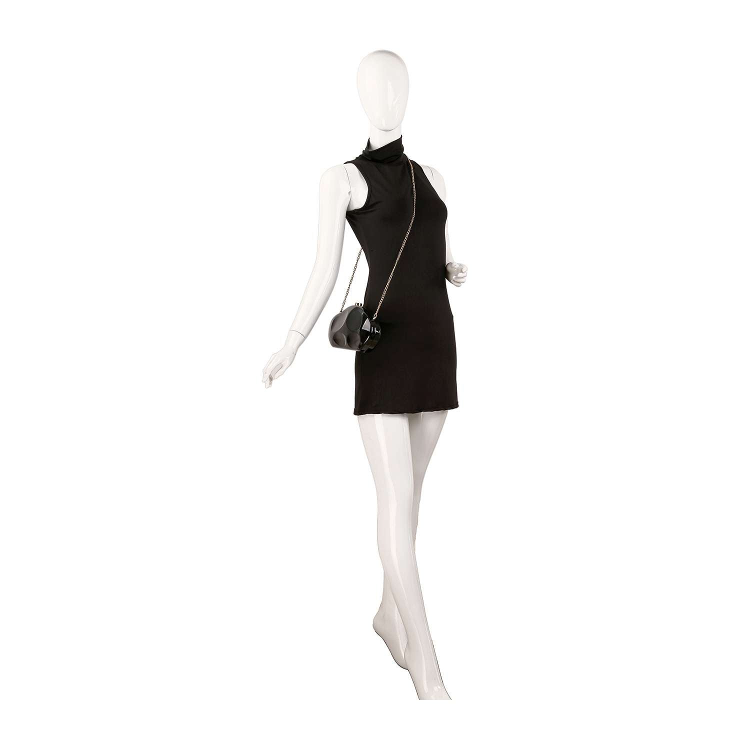 A white mannequin poses with one leg bent and an arm raised, wearing a sleeveless high-neck black mini dress and carrying the Modern Patent Petite Shoulder Bag, a small faux patent leather crossbody with a top clasp closure.