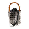 The Beaded Unique Evening Bag is a petite bucket bag with a bamboo handle, shiny silver beads, a stylish beaded silhouette, black drawstring closure, and long black ribbon ties.