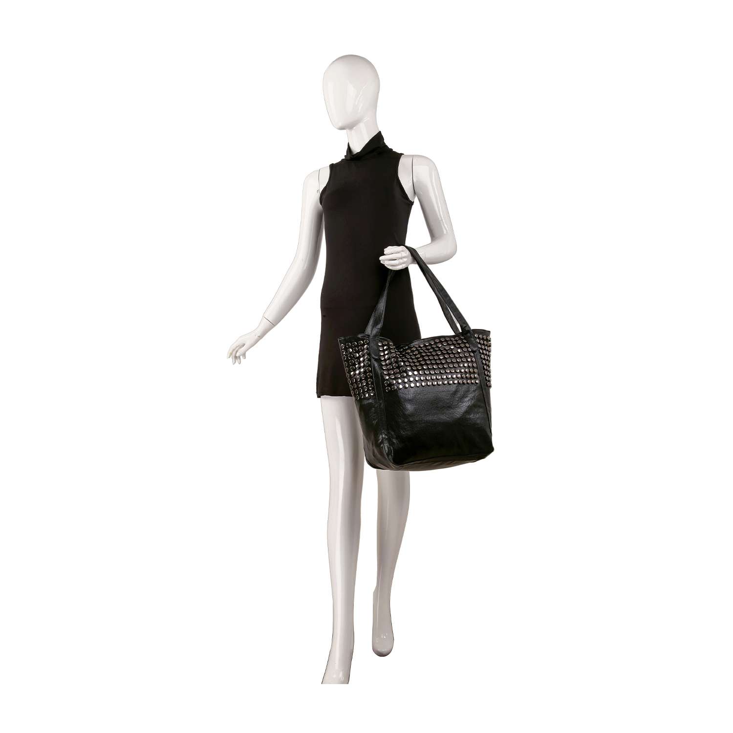 A mannequin in a sleeveless black dress holds the Large Studded Tote Handbag on its shoulder, walking forward against a white background.