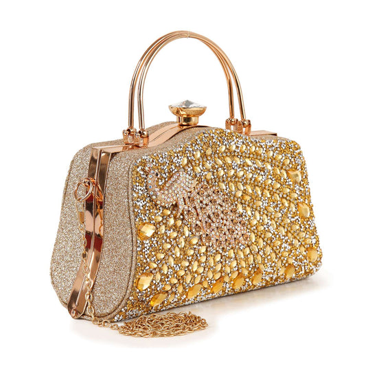 The Highly Decorative Peacock Accented Evening Bag features sparkling rhinestones, a jeweled clasp, metallic handle, gold chain strap, faux leather detailing, and an ornate peacock pattern on the front.