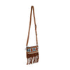 The Southwest Patterned Shoulder Bag features brown faux leather with colorful tribal Aztec prints, metal studs, an adjustable strap, and long brown fringe at the bottom. Displayed on a plain white background.