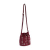 The Rivited Drawstring Hobo Shoulder Bag features a structured burgundy design with silver grommet accents, silver-tone hardware, and a long adjustable shoulder strap.