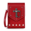 The Decorative Cross Accented Petite Crossbody Bag is a red rectangular faux leather bag with a wrist strap, silver cross medallion and chain on the flap, silver rivets, and five star-studded studs along the bottom front.