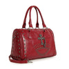 The Cross And Stud Accented Petite Satchel Handbag is a red faux leather bag with double handles, silver edge studs, a cross and curved front metal accent, plus a detachable strap for versatile carrying.