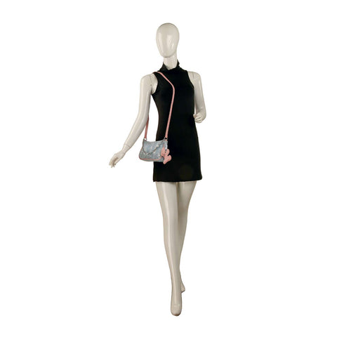 Mannequin wearing a sleeveless black mini dress and carrying the Denim And Sequin Decorative Hobo featuring a single strap, pink charm, and faux leather trim, posed against a white background.