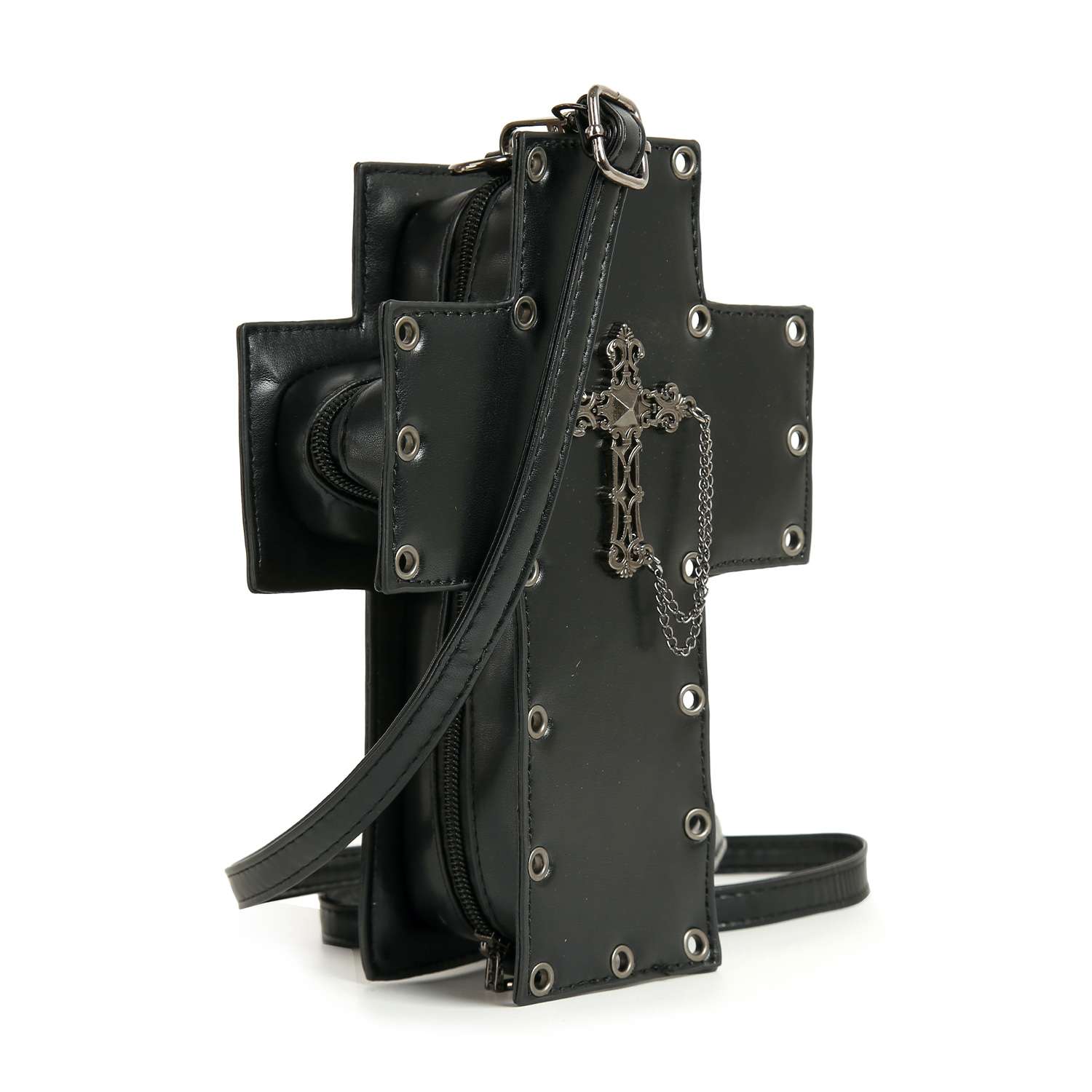 The Decorative Cross Design Crossbody Bag is a black, cross-shaped faux leather handbag with silver eyelets, a metal chain and cross pendant, adjustable strap, top zip closure, and a structured edgy look.