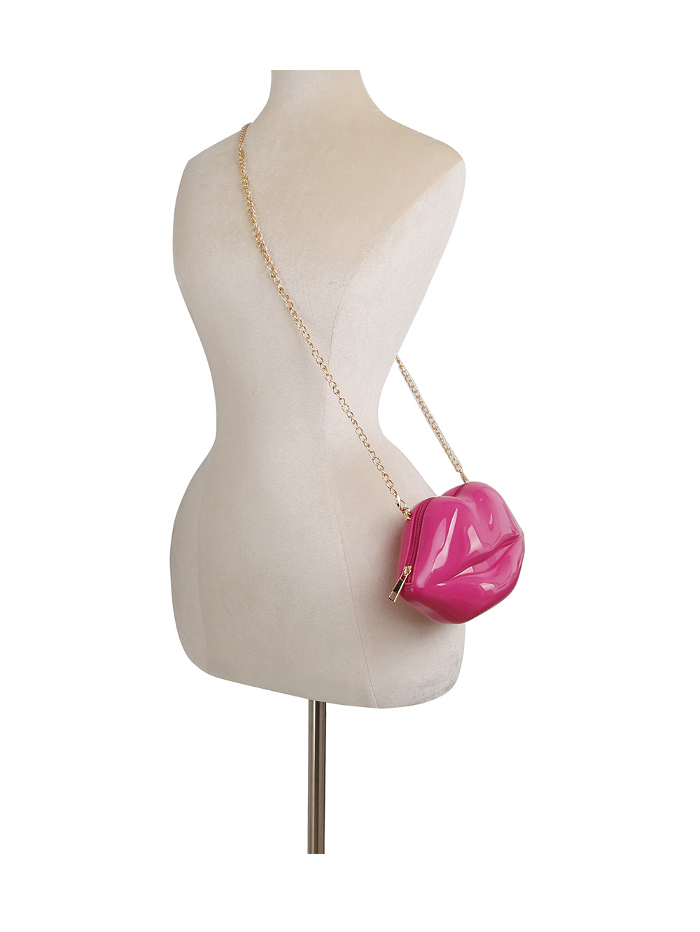 A mannequin displays the Kissable Lip Jelly Shoulder Bag—a small, shiny pink lip-shaped purse made from faux leather with a zip closure and a gold chain strap—slung across its shoulder.