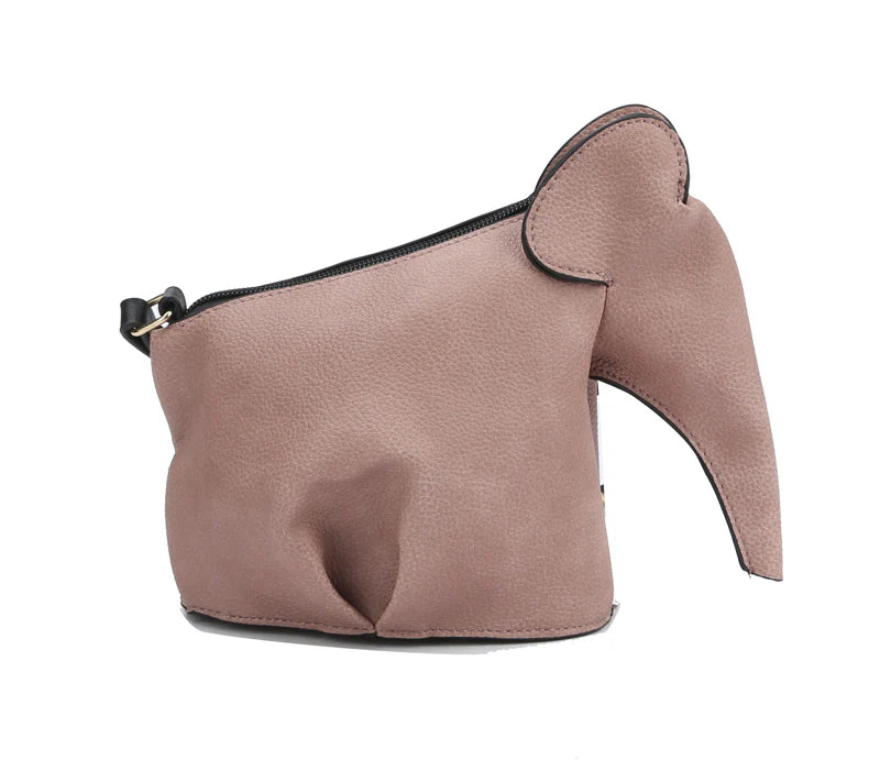 The Unique Elephant Design Shoulder Bag is a small, light brown faux leather handbag featuring a top zip, an ear detail, and a cute trunk-shaped extension on one side.