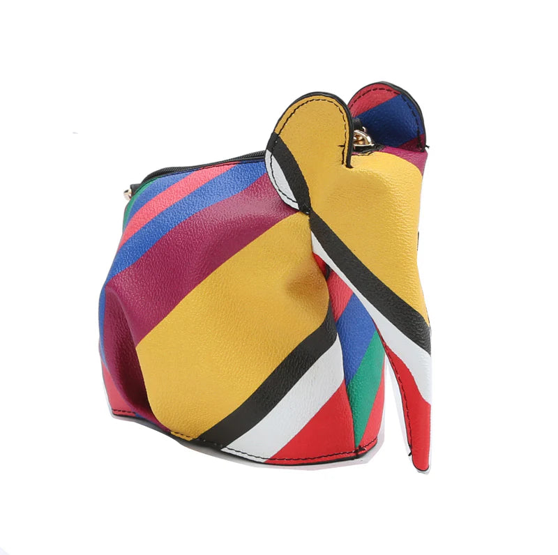 The Unique Elephant Design Shoulder Bag is a colorful, striped purse crafted from faux leather with yellow, red, blue, green, black, and white panels. It features an elephant shape and a top zip closure. Photographed against a plain white background.