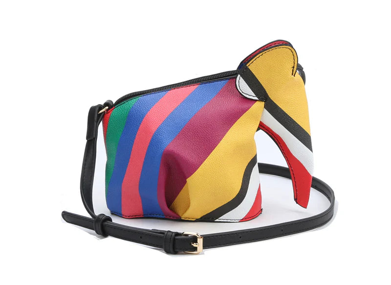 The Unique Elephant Design Shoulder Bag is crafted from faux leather with vibrant diagonal stripes in yellow, red, blue, green, purple, white, and black. It features a black adjustable strap, gold buckle, and a top zip closure for secure storage.