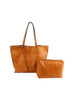 The Whipstitch Accented Luxurious Tote Set includes three tan faux leather accessories: a large handled tote, a rectangular zippered pouch, and a smaller cosmetic bag, all shown on a white background.
