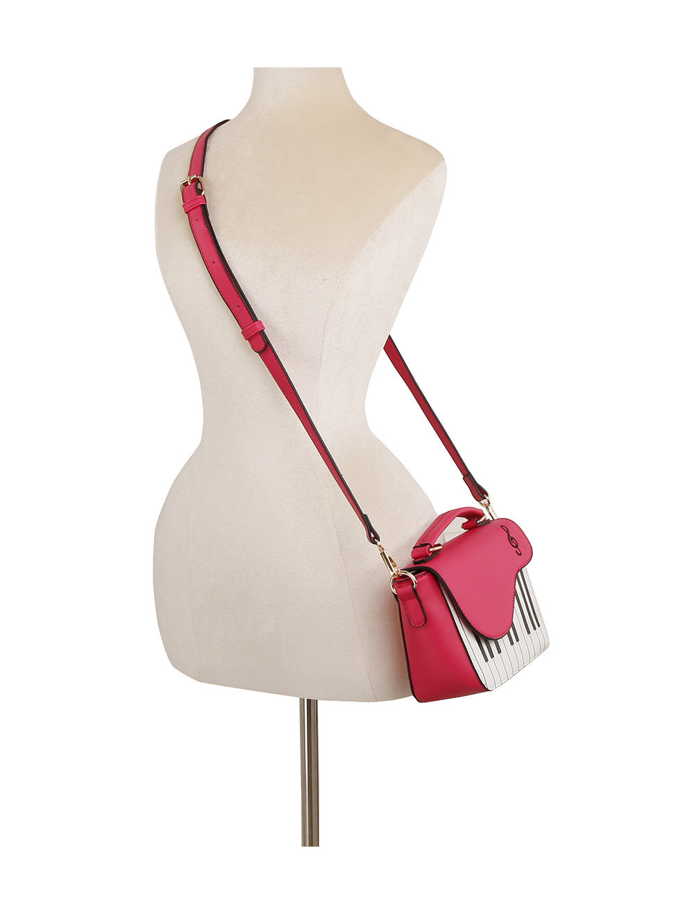 The Stylish Piano Design Hand Tote in pink faux leather, featuring a piano keys motif and matching adjustable strap, is displayed on a dress form mannequin worn crossbody.