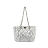 The Quilted Puffer Stylish Chain Accented Tote is a silver quilted nylon handbag with gold-toned hardware, a chain strap, and a rectangular front clasp, shown against a white background.