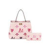 The Monogram Print Lux Faux Leather set features a light pink tote and matching wallet, adorned with pink and purple fleur-de-lis, crests, and an M. The tote includes two handles, gold-tone hardware, and a gold clasp.