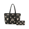 The Crest Emblem Classic Tote is a black tote bag with cream designs—fleur-de-lis, lion crest, and “M” monogram. This structured style includes a matching wallet, two-tone prints, and a detachable crossbody bag for added versatility.