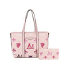 The Crest Emblem Classic Tote in light pink, adorned with pink, red, and maroon monograms, crests, and fleur-de-lis patterns, is paired with a matching wallet displayed in front of the tote.