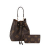 The 2 in 1 Monogram Print Faux Leather Bucket Bag features a brown design with gold M and fleur-de-lis patterns, a top handle, drawstring closure, tablet-friendly space, and includes a matching brown clutch.