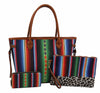 The Three Piece Canvas Print Tote Handbag Set features a large tote with colorful stripes and brown handles, plus a leopard print wristlet and matching wallet, all displayed against a white background.