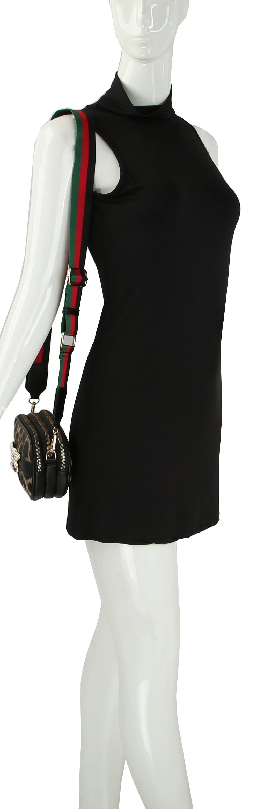 A mannequin wearing a sleeveless black dress and the Rhinestone Bee Leopard Print Crossbody Bag, featuring a green and red striped adjustable strap and a decorative clasp for added style.