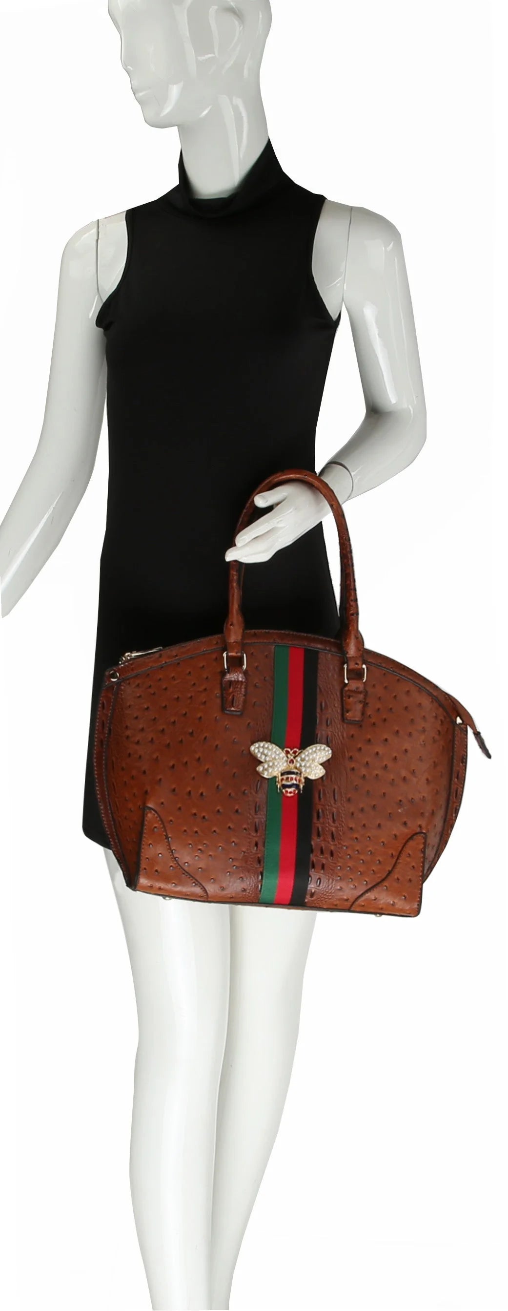 A mannequin in a sleeveless black dress holds the Rhinestone Bee Large Tote Handbag, featuring brown faux leather, green and red stripes, a gold bee emblem, and gold-toned hardware.